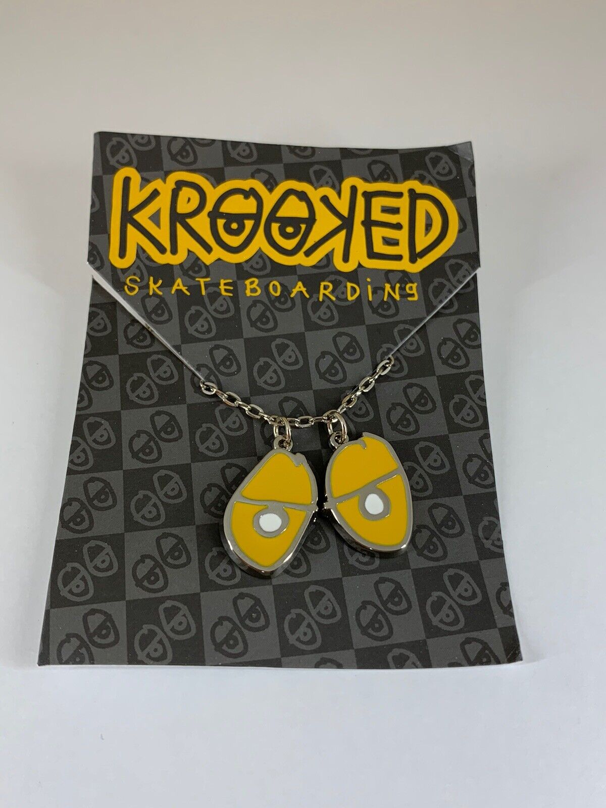 Krooked Eyes Skateboard Pendant mens unisex Necklace Silver/Yellow NWT